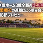 夕方の日差しが差し込む沖縄の陸上競技場のピッチとスタンドを見渡した写真